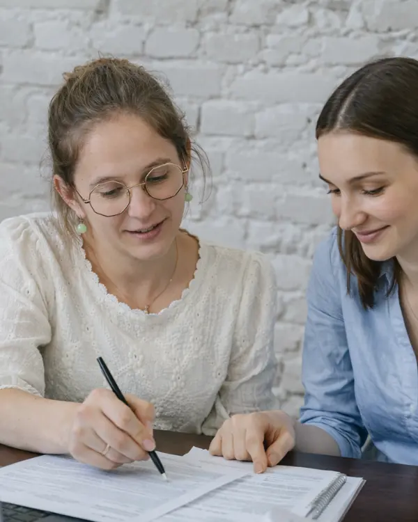 Deux femmes en train de travailler ensemble sur un document
